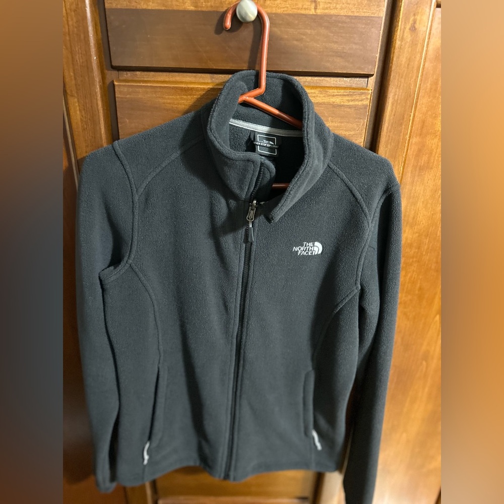 The North Face black zip up sweater.